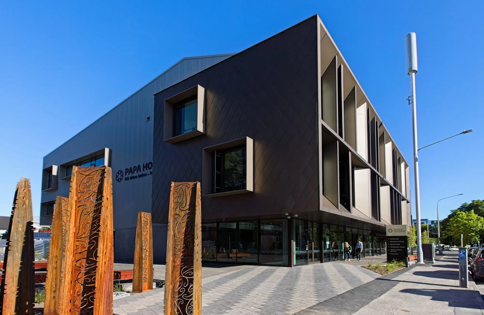 Papa Hou building on Rolleston Avenue in central Christchurch, home of the Abigail Dance Coaching studios, with carved timber pou at the entrance