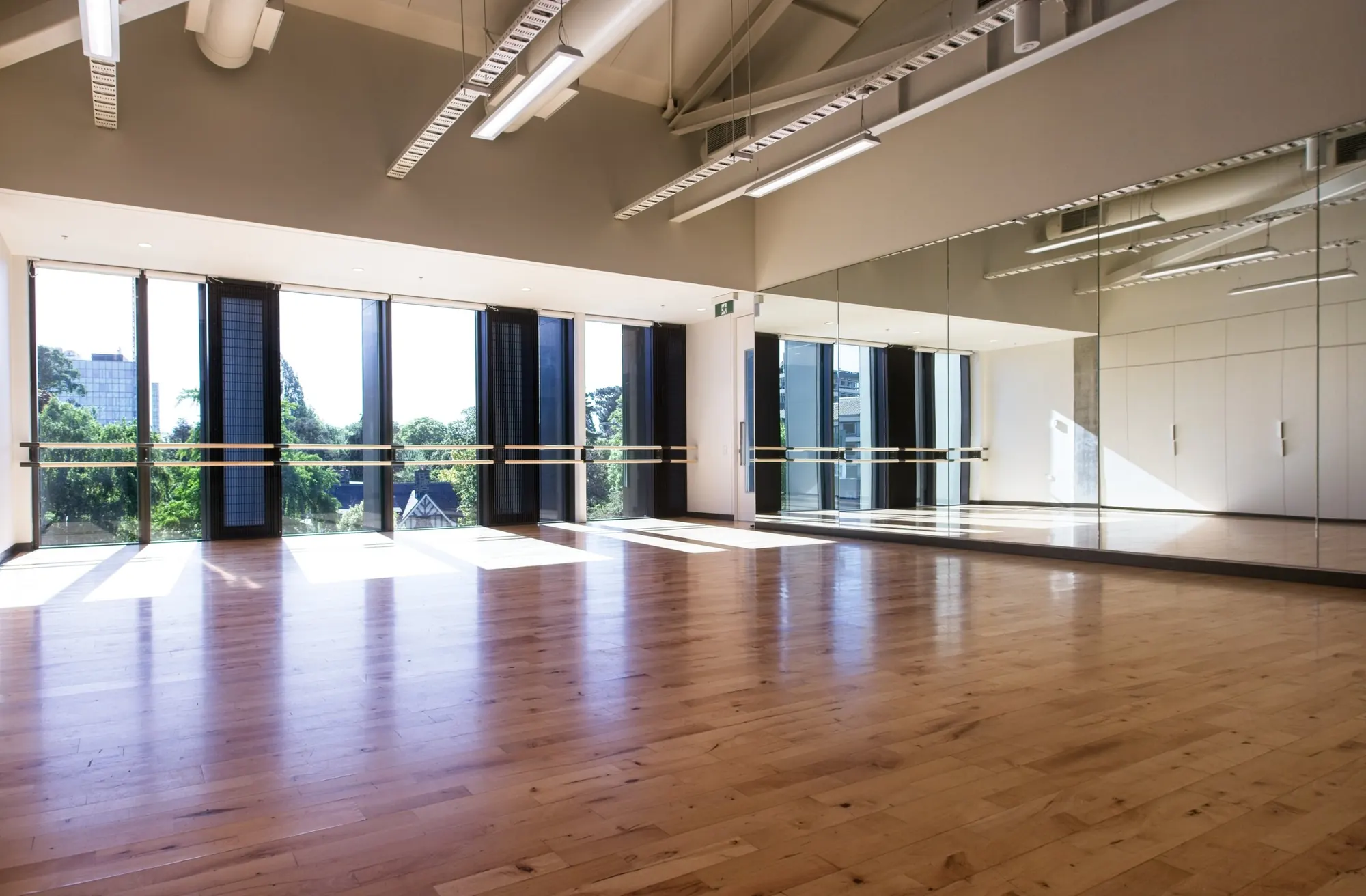 Sunlit dance studio at Papa Hou, Christchurch, with sprung timber floor, ballet barres and full length windows, where Abigail Dance Coaching classes are held